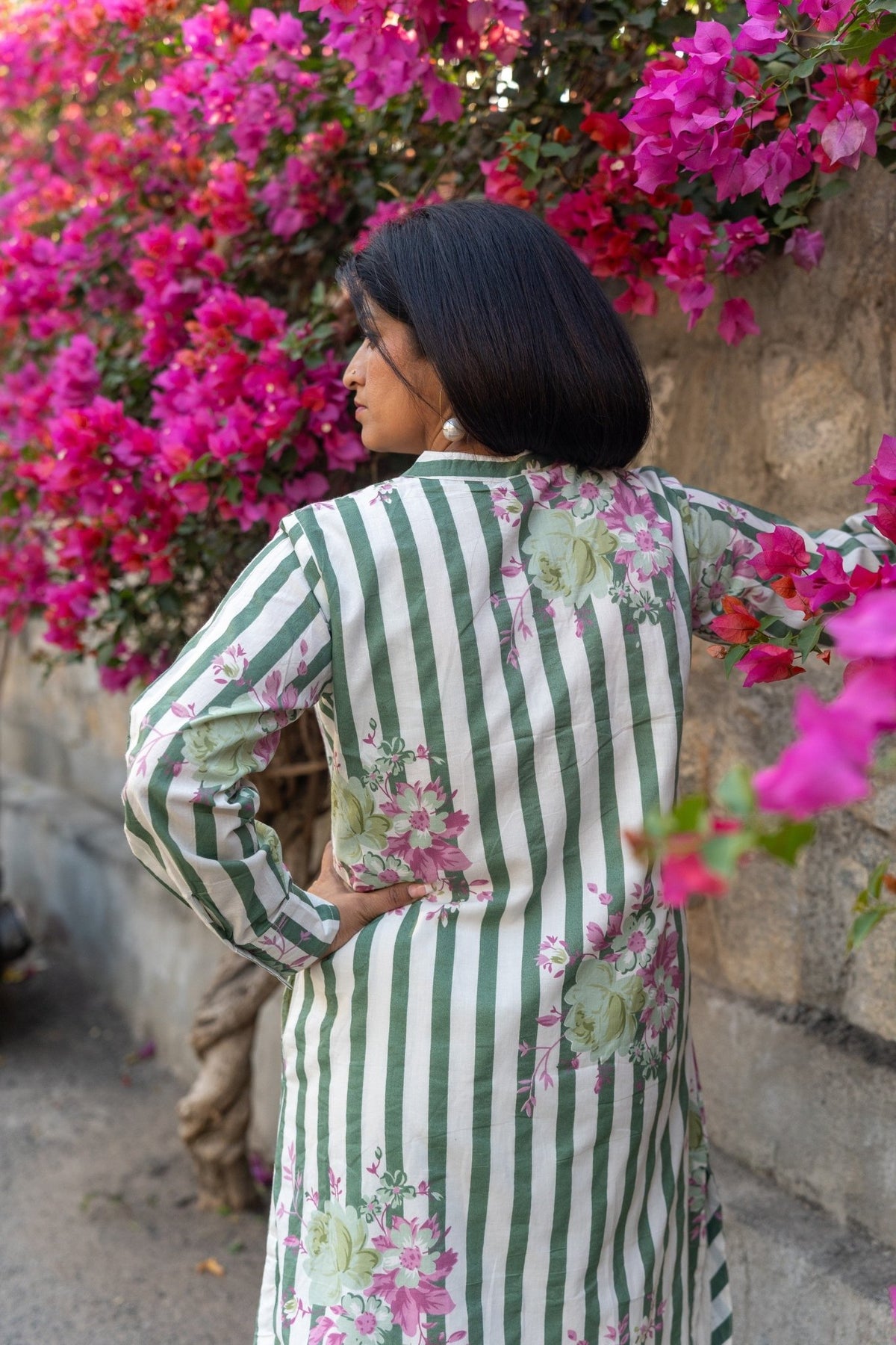 Close-up of green stripe cotton fabric and wooden buttons on co-ord top